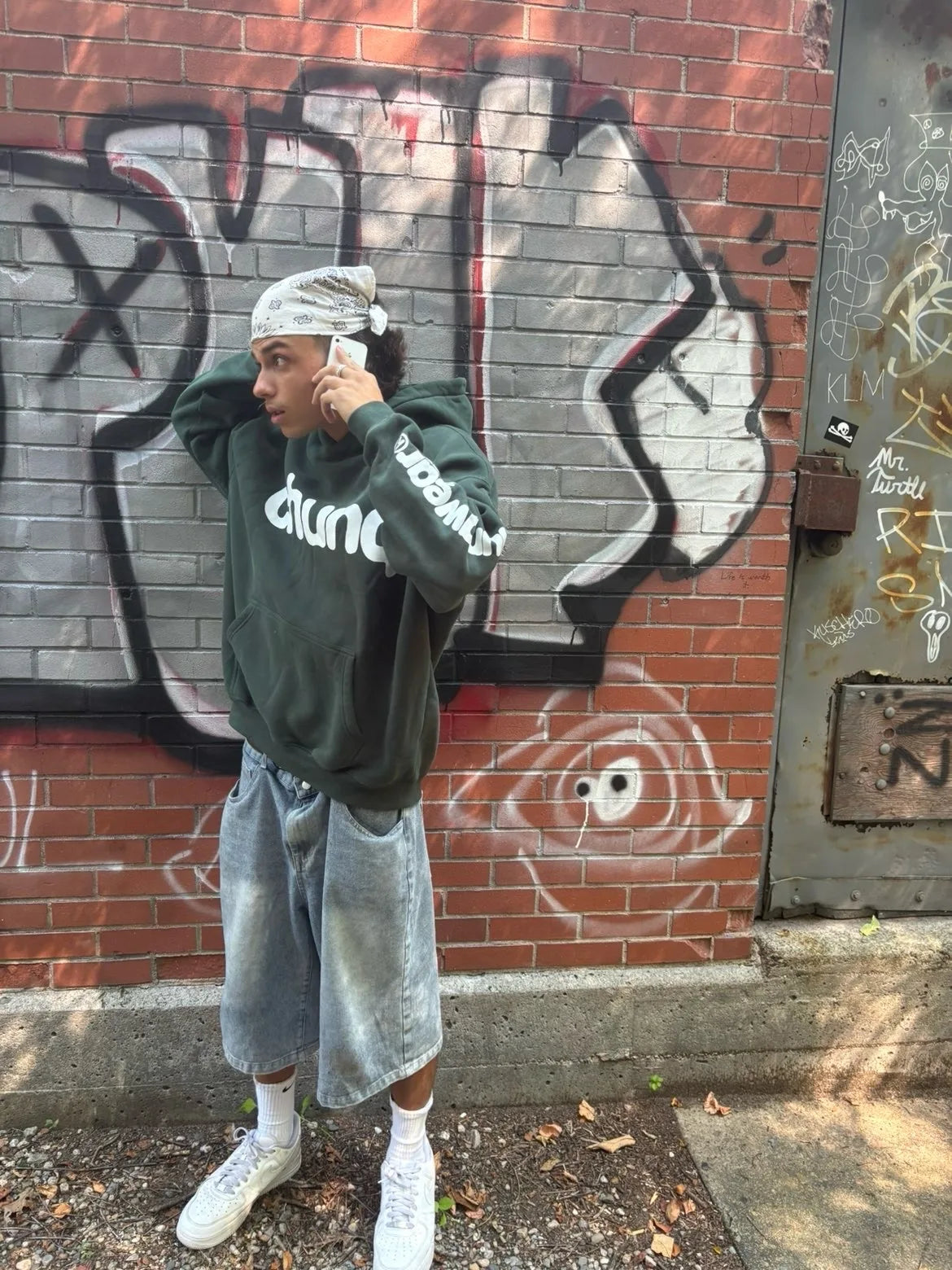 Model wearing a green Chunq hoodie by graffiti